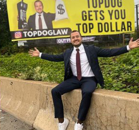 Arizona slip and fall Lawyer James Helm cheering in front of TopDog Billboard