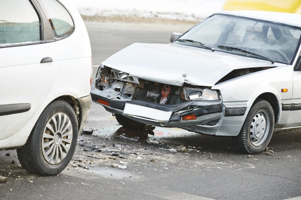 Urban roadway collision aftermath - vehicle crash on a city highway, illustrating the impact of a car accident.
